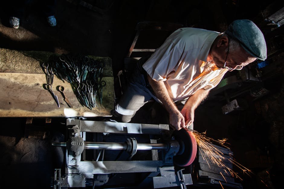 Traditional craftsman sharpening scissors using a grinder in a Yatağan workshop.
