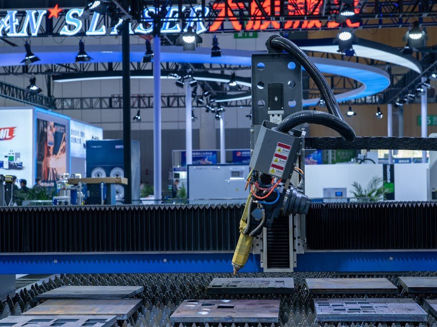 A CNC laser machine operating in a high-tech industrial exhibition setup with vibrant lighting.